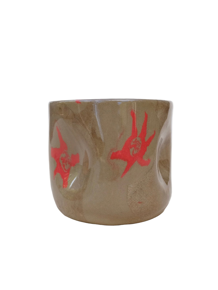 nerikomi hug mug Ceramic cup with red abstract designs on a white background